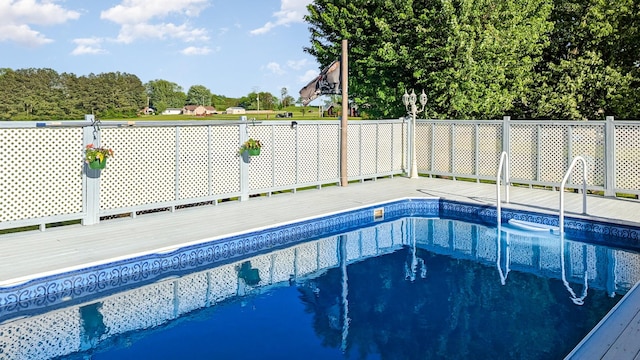 view of swimming pool with a fenced in pool and fence