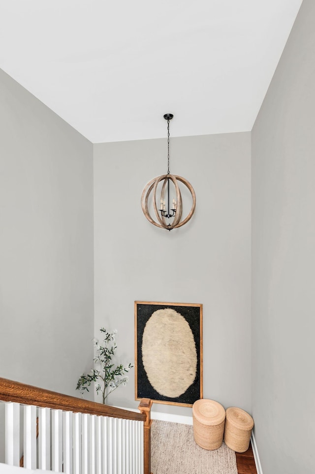 interior space with a chandelier, wood finished floors, and baseboards