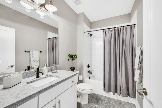 full bathroom featuring toilet, vanity, visible vents, tile patterned floors, and shower / tub combo with curtain