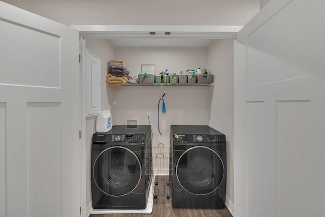 washroom with laundry area, wood finished floors, and washer and dryer