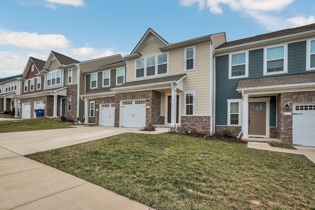 townhome / multi-family property featuring a garage, driveway, stone siding, a residential view, and a front yard