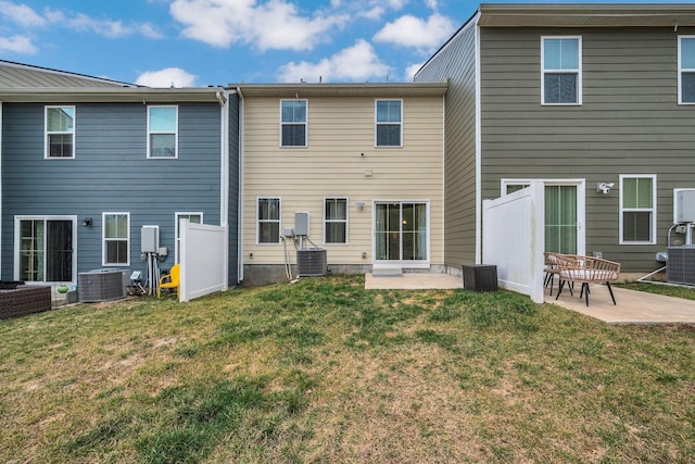 back of house featuring a yard, central AC unit, and a patio