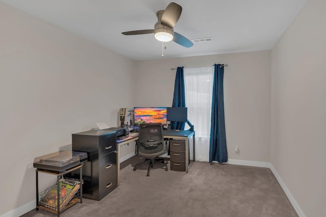 office space featuring a ceiling fan, light carpet, visible vents, and baseboards