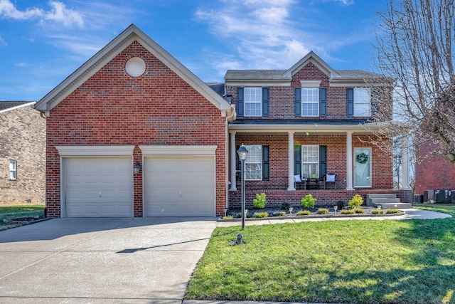 traditional home with a garage, concrete driveway, brick siding, and a front yard