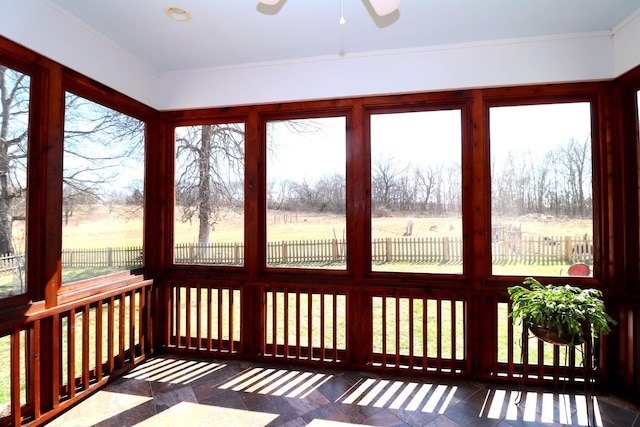 unfurnished sunroom with a wealth of natural light and a ceiling fan