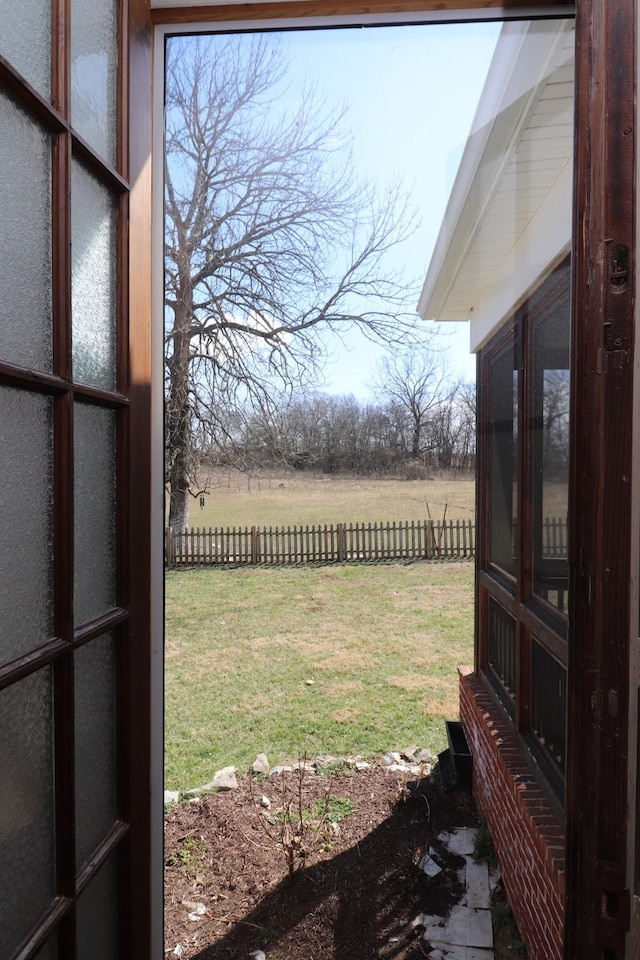 view of yard with a rural view and fence