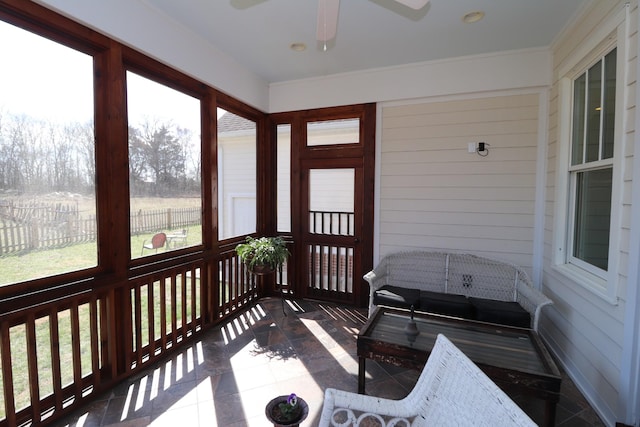 sunroom featuring a ceiling fan