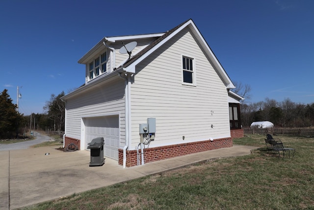 view of side of property featuring driveway, a lawn, an attached garage, and fence