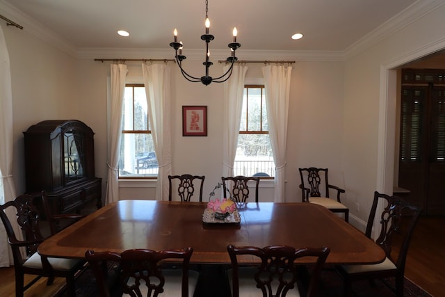 dining room with recessed lighting, crown molding, and wood finished floors