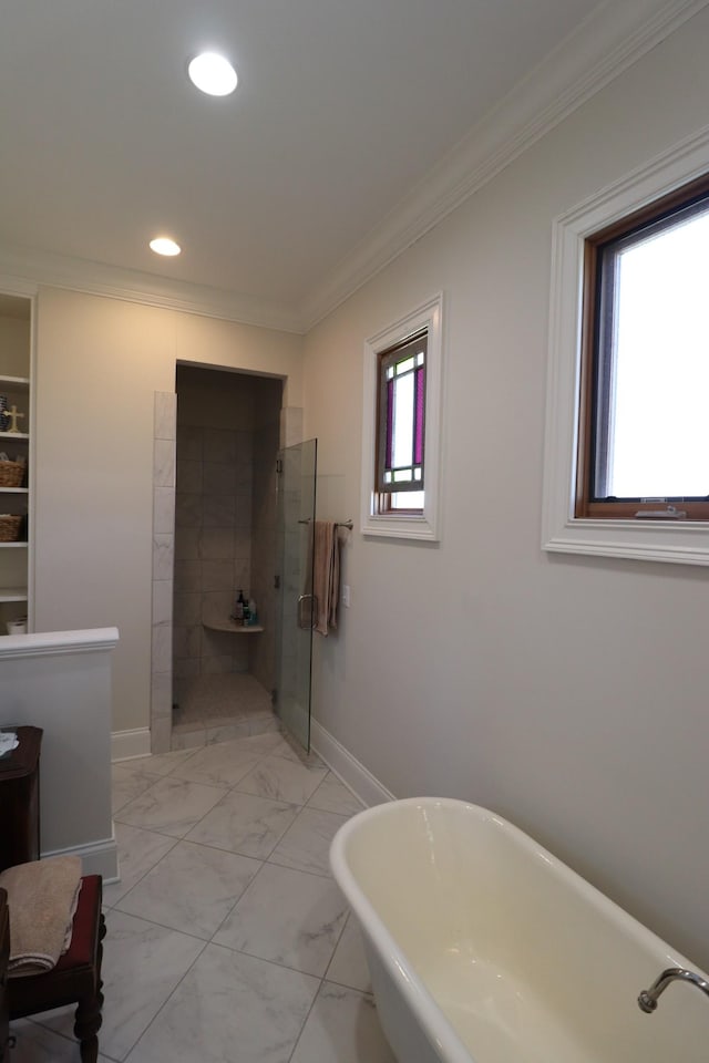 bathroom featuring crown molding, baseboards, tiled shower, a soaking tub, and marble finish floor