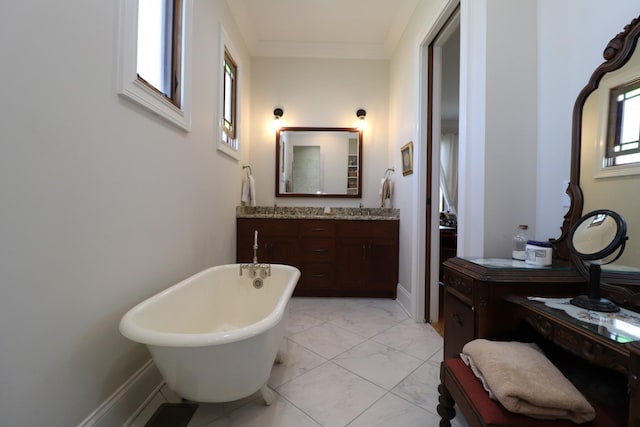 full bath featuring crown molding, baseboards, a freestanding bath, marble finish floor, and vanity