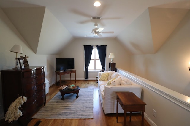 living room with vaulted ceiling, wood finished floors, a ceiling fan, and visible vents