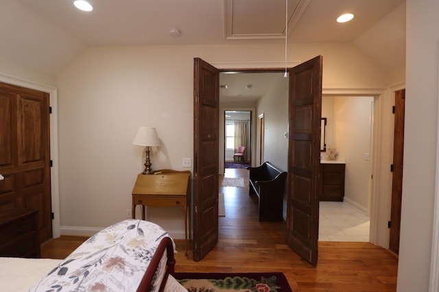 bedroom featuring attic access, recessed lighting, light wood-type flooring, and vaulted ceiling