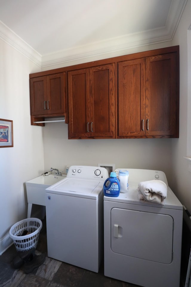 washroom featuring washer and dryer, a sink, cabinet space, crown molding, and baseboards