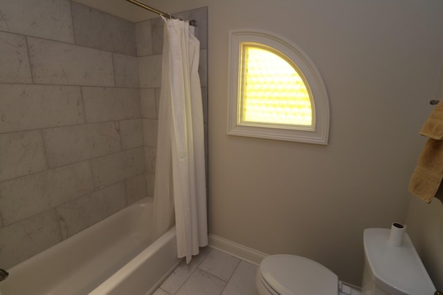 bathroom featuring shower / bath combination with curtain, marble finish floor, toilet, and baseboards