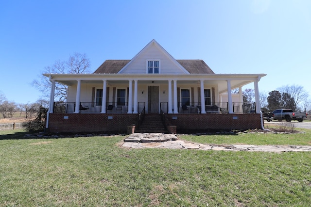 view of front of home featuring covered porch and a front yard