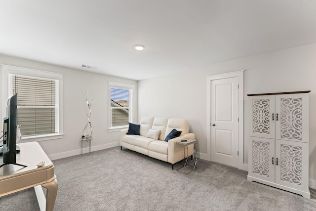 living area featuring visible vents, baseboards, and carpet flooring