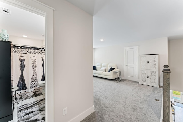 hall featuring recessed lighting, carpet, visible vents, and baseboards