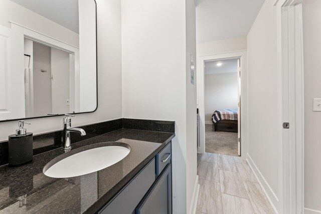 bathroom with vanity and baseboards