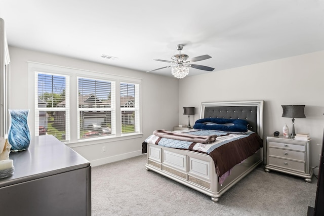 carpeted bedroom with visible vents, ceiling fan, and baseboards