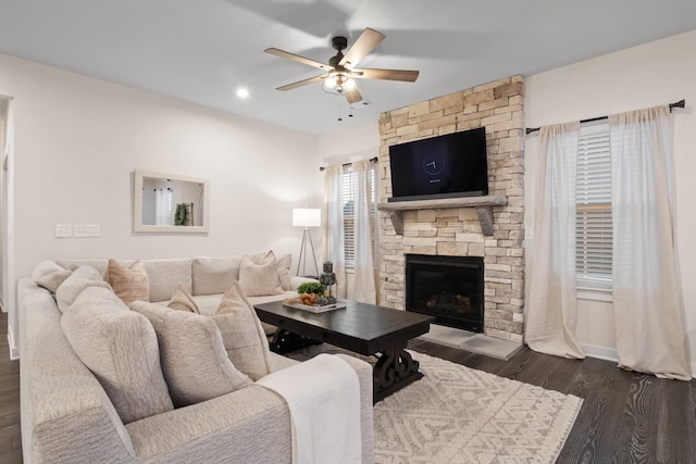 living area featuring a ceiling fan, recessed lighting, dark wood-style flooring, and a fireplace