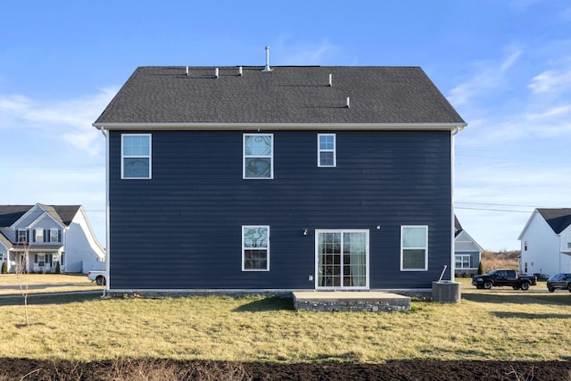 rear view of property with a yard, central AC unit, a patio, and a shingled roof