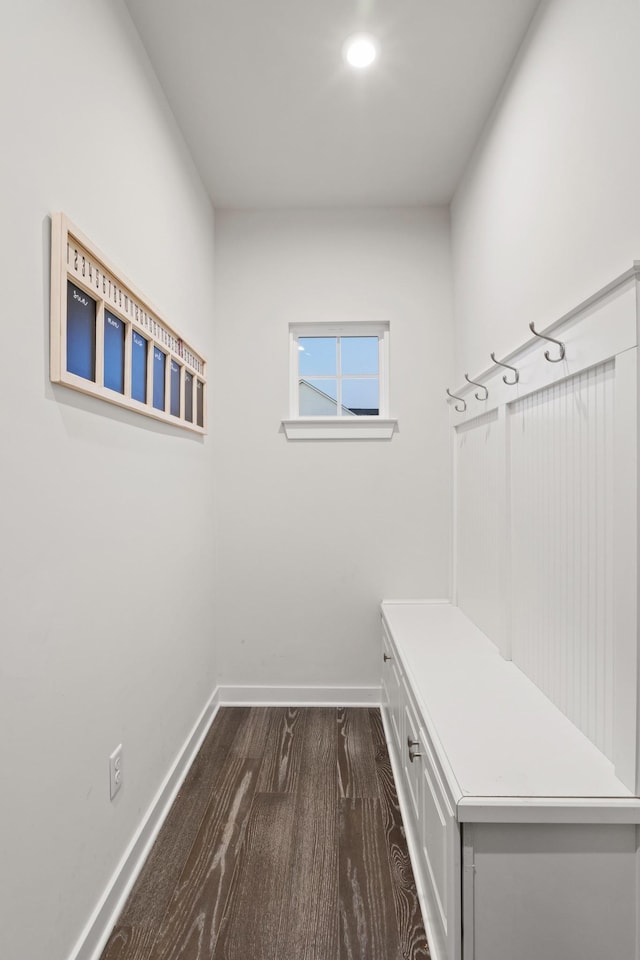 mudroom featuring dark wood-style floors and baseboards