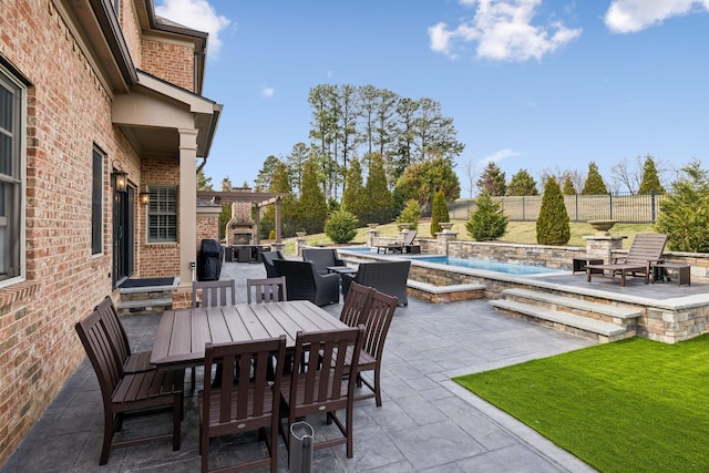 view of patio featuring an outdoor pool, a fenced backyard, and outdoor dining area