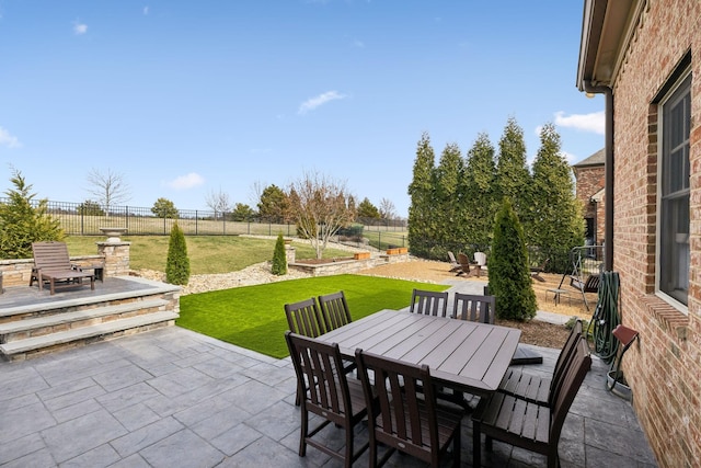 view of patio featuring outdoor dining space and a fenced backyard