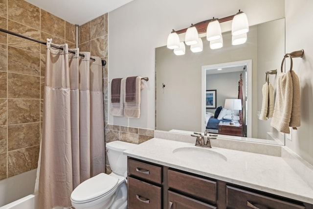 ensuite bathroom with shower / tub combo with curtain, tile walls, toilet, connected bathroom, and vanity