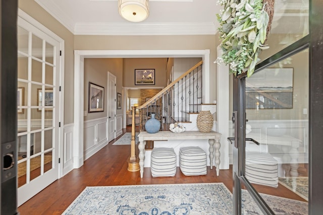 entrance foyer featuring stairway, ornamental molding, and wood finished floors