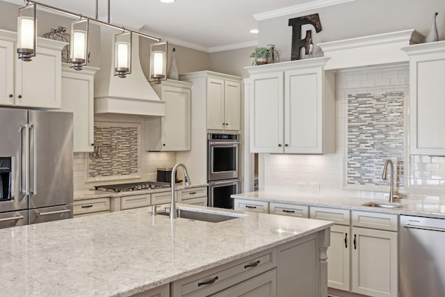 kitchen with appliances with stainless steel finishes, tasteful backsplash, a sink, and ornamental molding