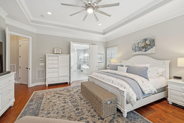 bedroom with dark wood-type flooring, a raised ceiling, visible vents, and crown molding