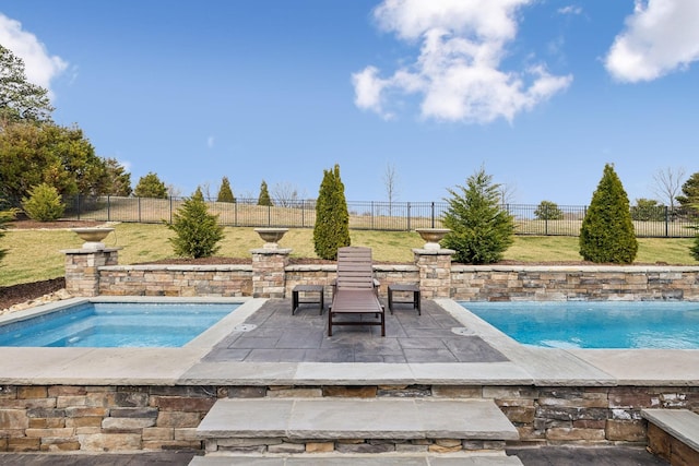 view of swimming pool featuring an in ground hot tub, a patio area, and a fenced backyard