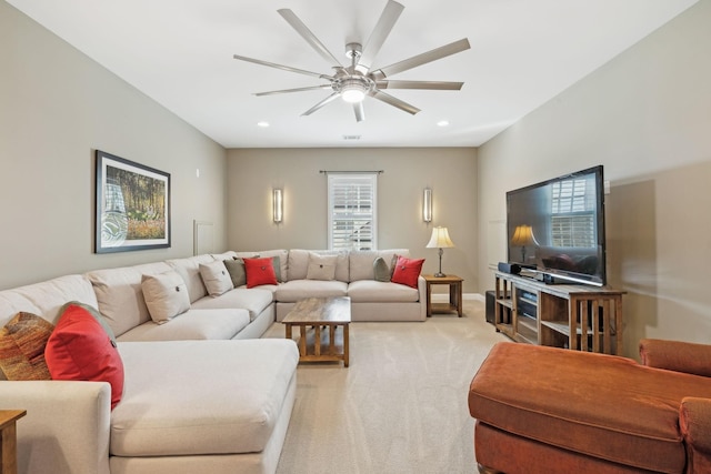 living area featuring light carpet, ceiling fan, baseboards, and recessed lighting