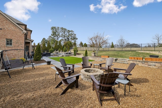 view of yard featuring a patio, an outdoor fire pit, and fence