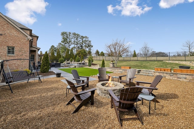 view of yard featuring fence, a fire pit, and a patio