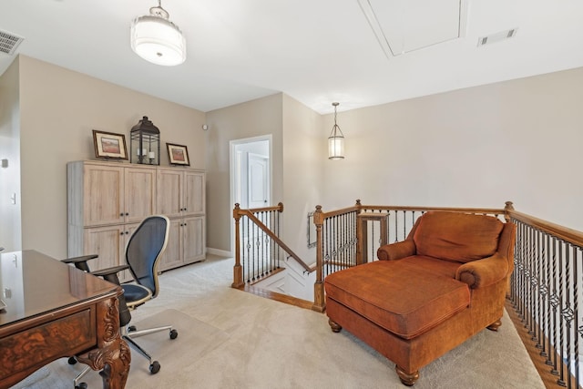 office space featuring light carpet, attic access, visible vents, and baseboards