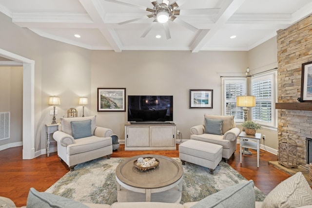 living area with beam ceiling, coffered ceiling, a fireplace, and wood finished floors