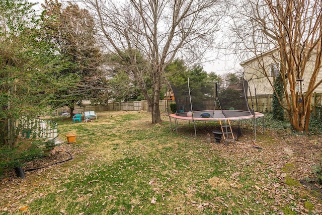 view of yard featuring a fenced backyard and a trampoline