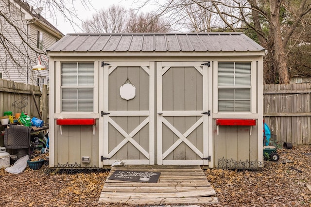 view of shed featuring fence