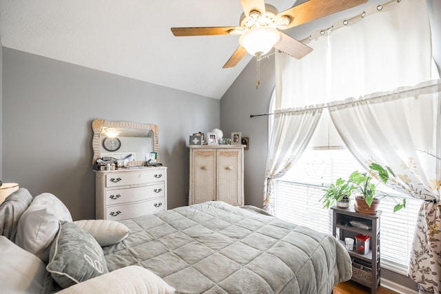 bedroom featuring lofted ceiling and a ceiling fan