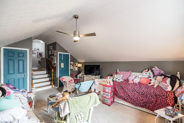 carpeted bedroom featuring lofted ceiling and a ceiling fan