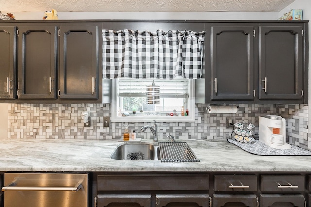 kitchen with a textured ceiling, a sink, dark brown cabinets, stainless steel dishwasher, and backsplash