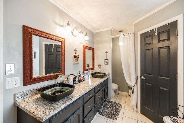 full bath with toilet, double vanity, ornamental molding, and a sink