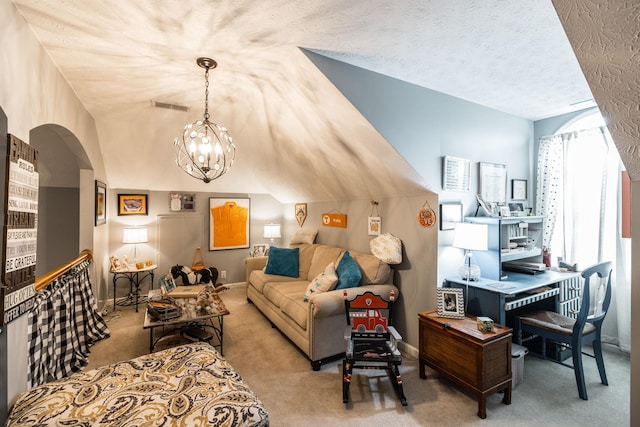 living area with a textured ceiling, a notable chandelier, carpet floors, visible vents, and vaulted ceiling