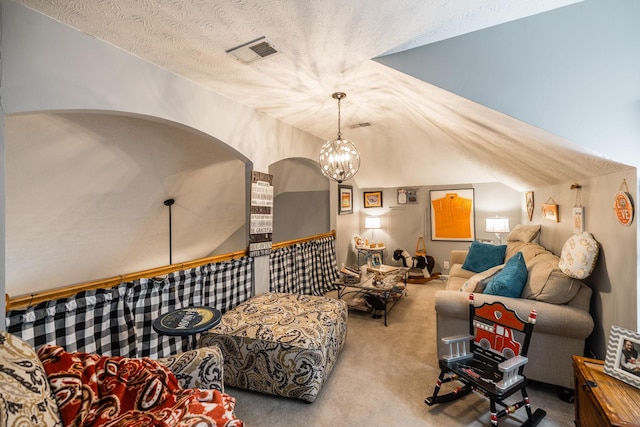 sitting room featuring carpet floors, visible vents, vaulted ceiling, and a textured ceiling