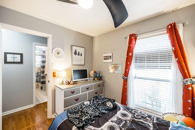 bedroom featuring ceiling fan, baseboards, and hardwood / wood-style floors