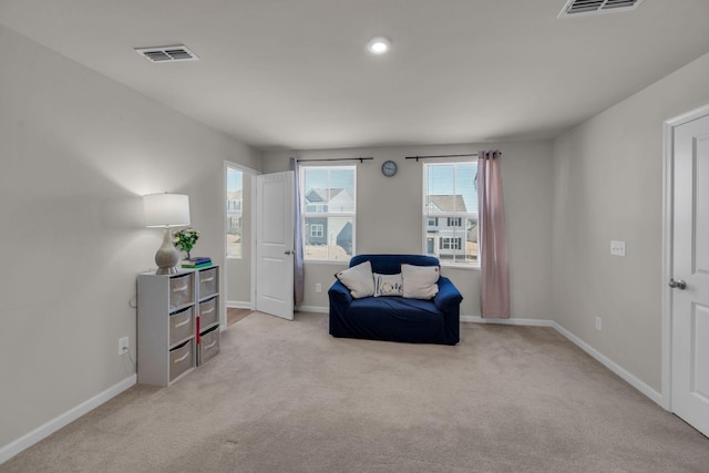 sitting room with carpet flooring, visible vents, and baseboards