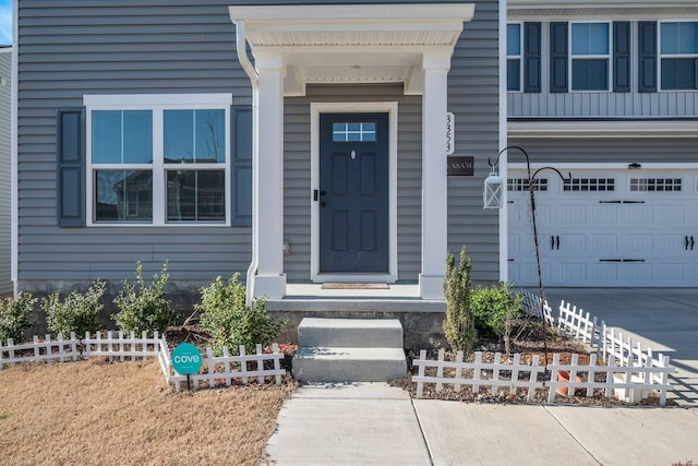 property entrance featuring a garage and driveway